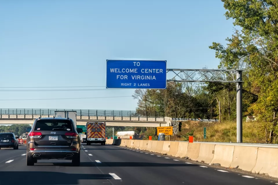 Interstate 95 near Fredericksburg, Virginia with blue sign that says "To Welcome Center for Virginia"